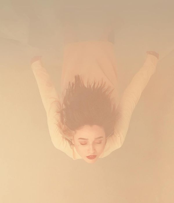 Woman in a tranquil pose with honey-colored light.